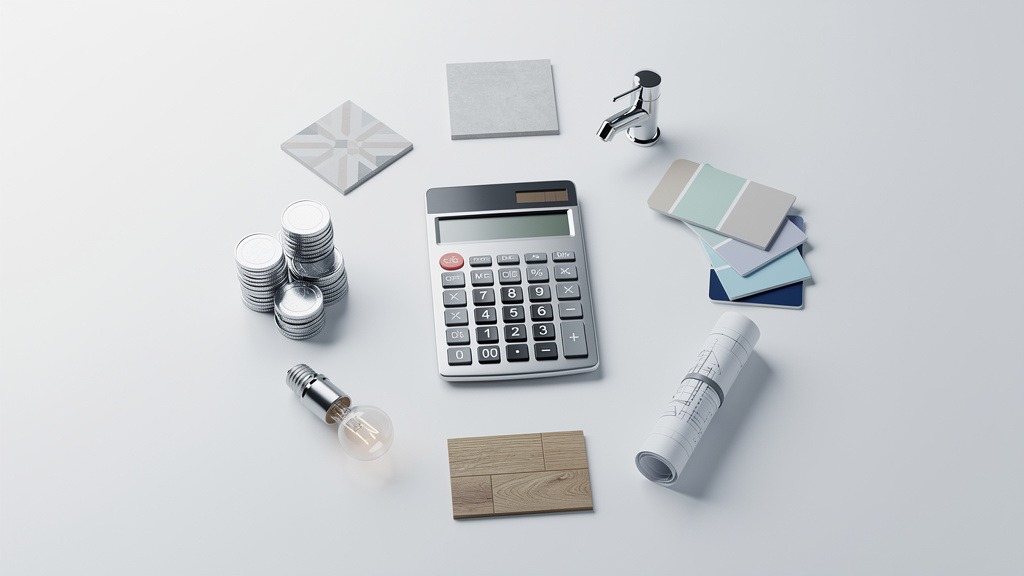 An overhead view of a calculator surrounded by small objects representing bathroom renovation costs like a tile, faucet, and paint swatch.